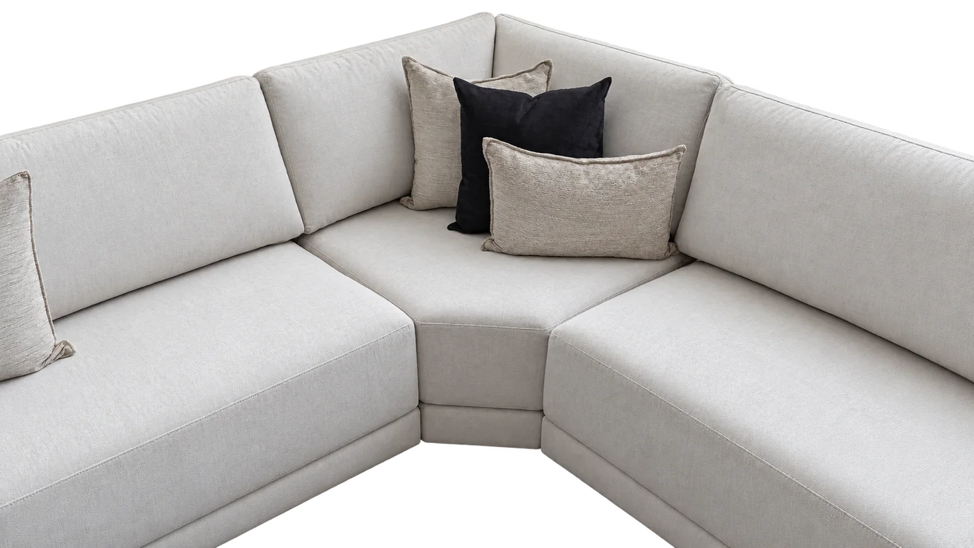 Light upholstered sectional corner with coordinating loose pillows